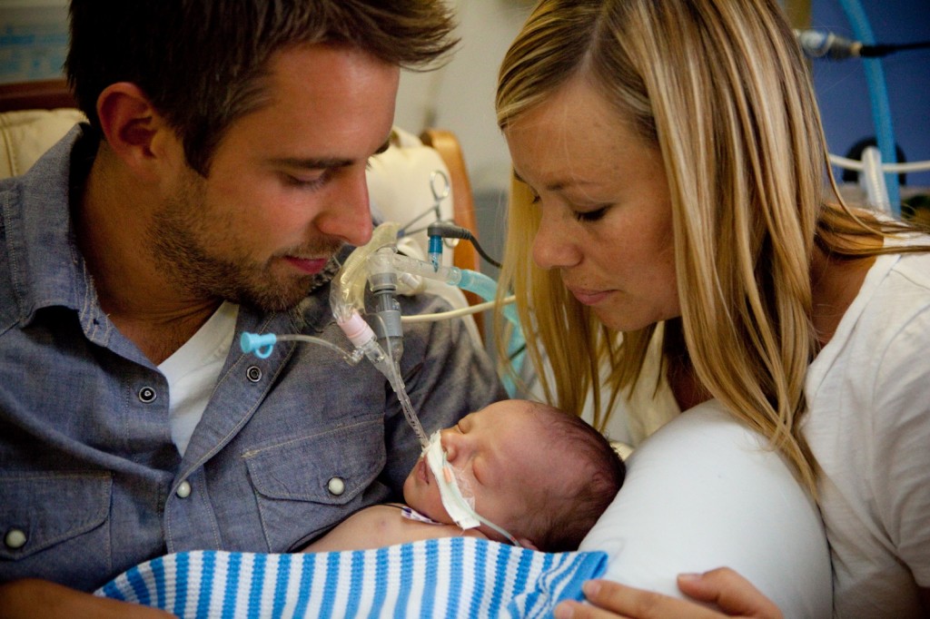 Matt and Sarah Hammit hold Bowen in the hospital as he fights for his life. They chose life for their son.