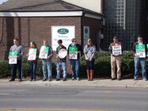 Young pro-life activists pray outside the Alabama Women's Center for Reproductive Alternatives. 