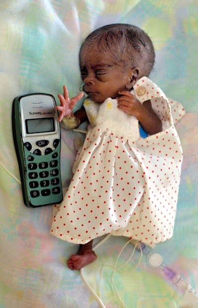Tiny Aaliyah next to a device