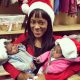 A pregnancy resource center employee, with with her client's twins. The babies were born close to Christmas after their mother changed her mind about abortion.