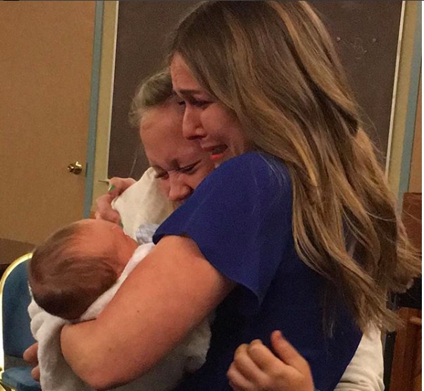 Emily weeps with joy as she meets her adopted son. (Photo credit: Hannah Mongie's Instagram)