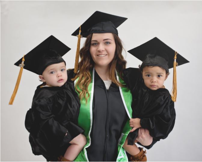 Kelsey and her twin girls are ready for graduation in their caps and gowns. Kelsey refused abortion with help from a pregnancy help center.