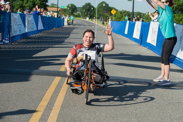 Sen. Duckworth, who supports unlimited abortions for women, participates in a race using an adapted bike.