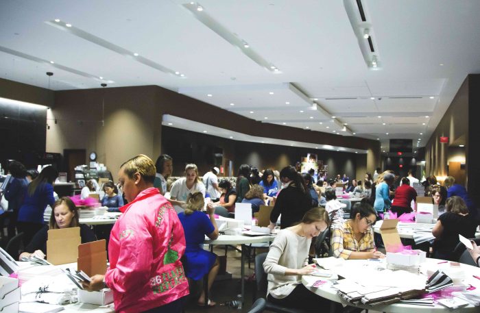 Volunteers work on Embrace Grace Love Boxes. 