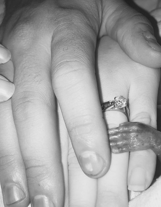 Baby Luke's parents hold his tiny hand after he was born prematurely at 18 and a half weeks gestation. Photo courtesy of Meghann Jacobs.