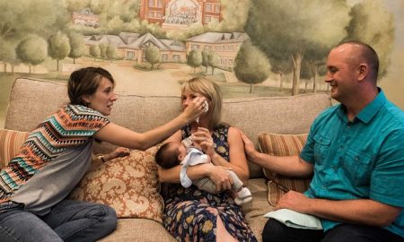 Birth mom wipes the tears of adoptive mom. Copyright Sara Liz Photography.