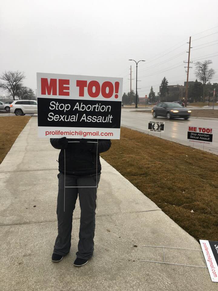 Image: Pro-lifer holds MeToo sign outside abortion facility (Image credit: Lynn Mills) 