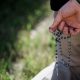 prayer, spain, violence against man praying rosary at Planned Parenthood