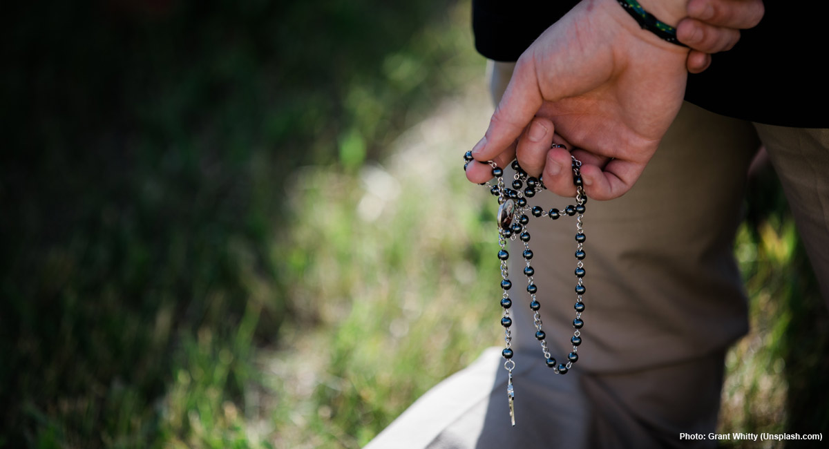 prayer, spain, violence against man praying rosary at Planned Parenthood