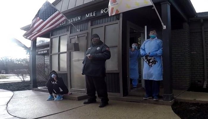 Image: Abortion staffers in full PPE during COVID-19 pandemic outside abortion clinic in Michigan (Photo credit: Lynn Mills)