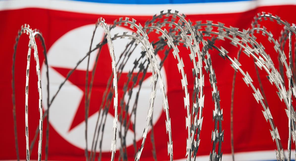 Barbed wire and North Korean national flag DPRK
