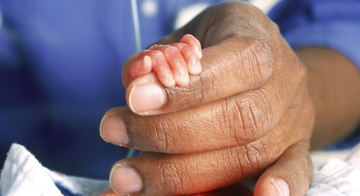 premature babys hand in doctors