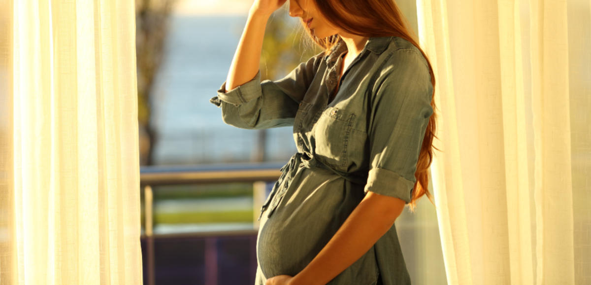 Worried pregnant woman complaining at home