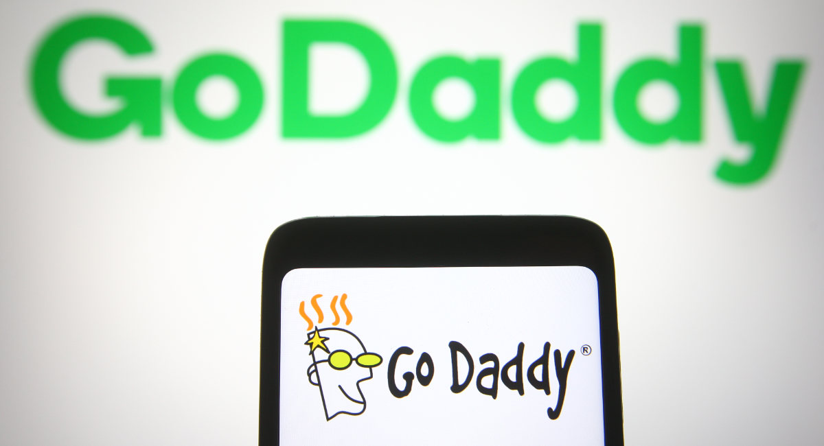 In this photo illustration the GoDaddy logo is seen on a