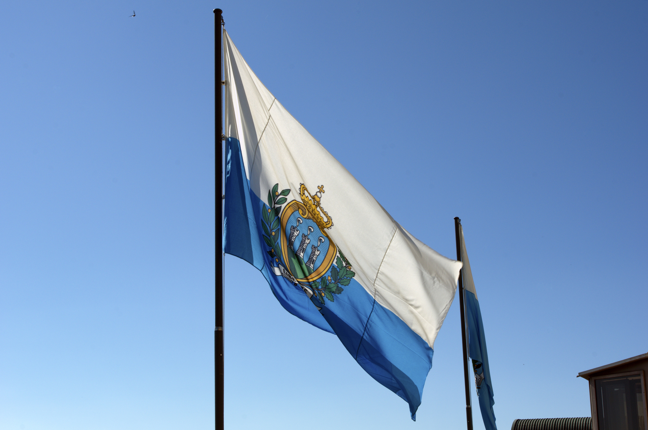 Low Angle View Of Flags Against Clear Blue Sky