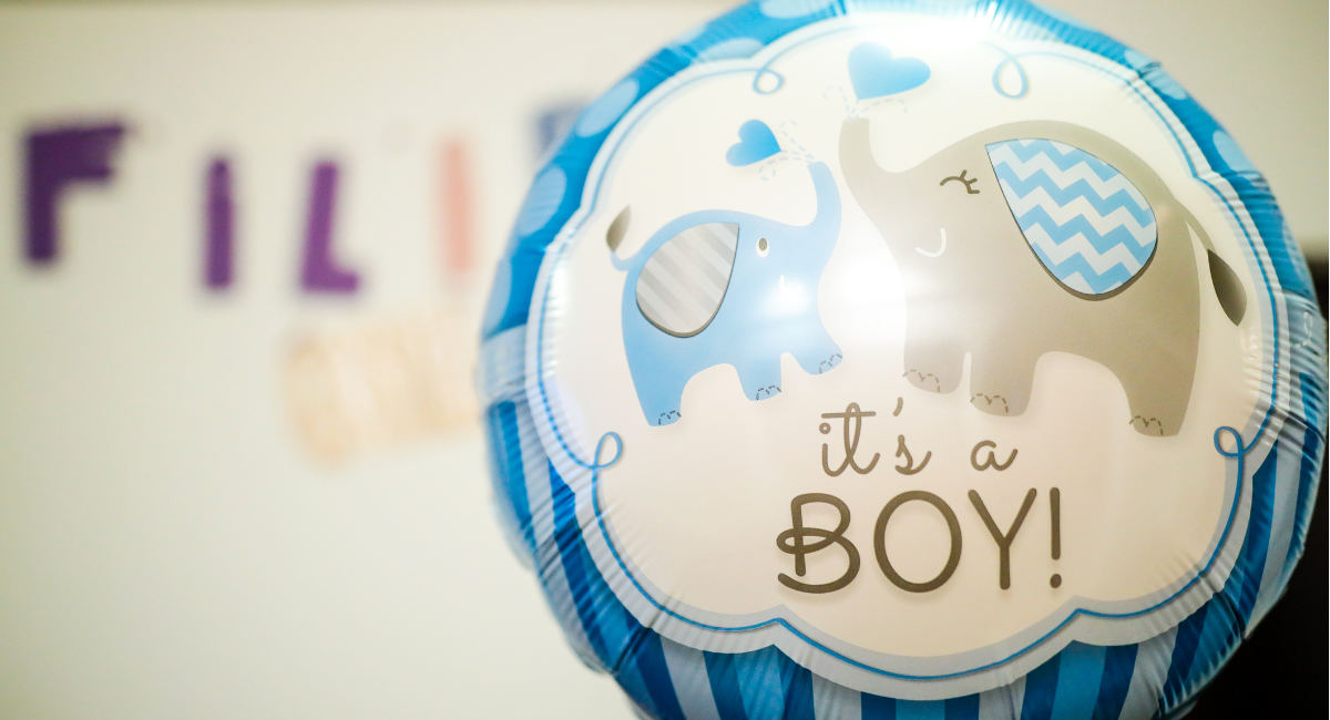 Shallow depth of field (selective focus) image with a It”u2019s a boy message on a balloon during a baby shower