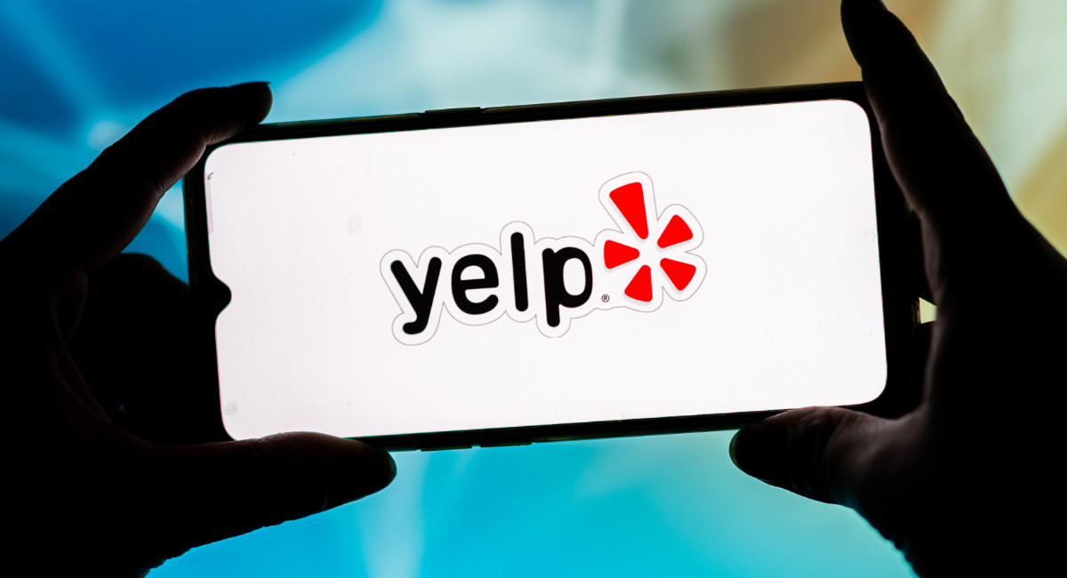 In this photo illustration, a Yelp logo seen displayed on a