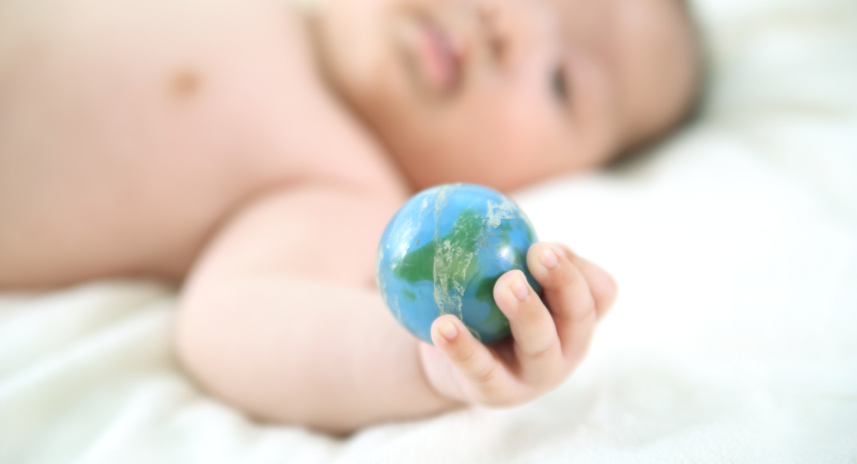 Baby holding globe