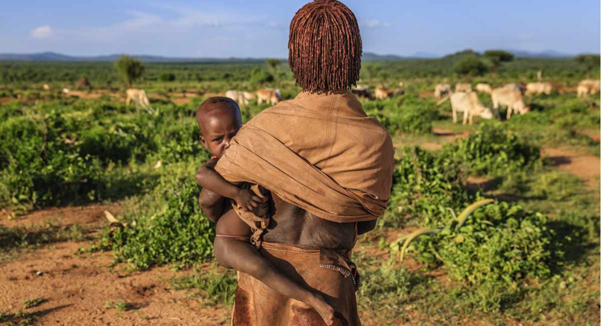 Woman from Hamer tribe carrying her baby, Ethiopia, Africa