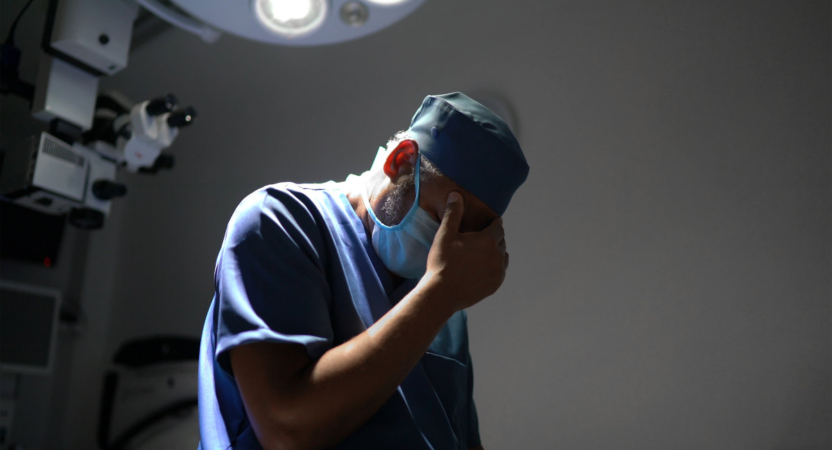 Worried healthcare male nurse at operating room in hospital