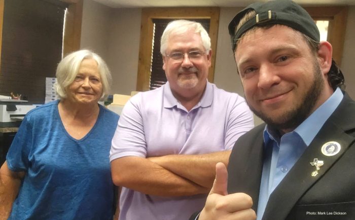Both of Talco's city commissioners pose for a photo with Mark Lee Dickson